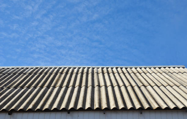istock Asbestos roof removal. Asbestos house roofing construction. 1049201480