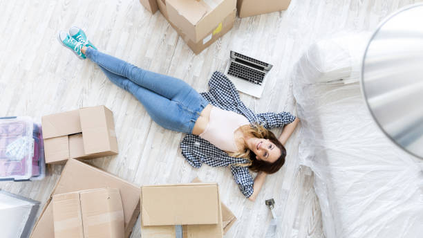 istock Young woman resting on floor in new home 1049201822