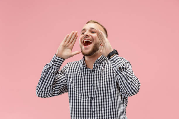 istock Isolated on pink young casual man shouting at studio 1049201922