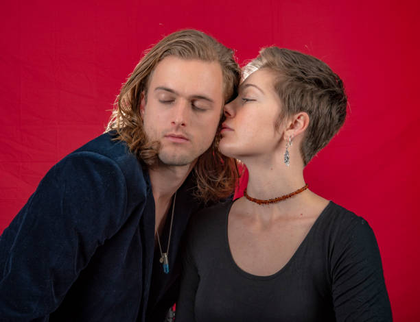 istock Young affectionate couple. Eyes closed. She kisses him. 1049202160