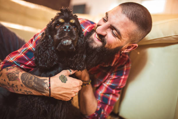 istock Handsome man with cute dog at home 1049202222
