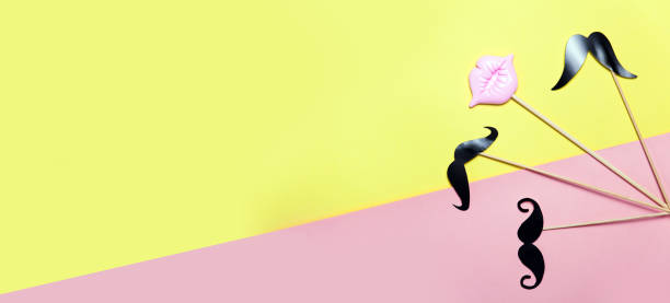 istock Creative confetti background with pink lips and mustache. Top view 1049203664