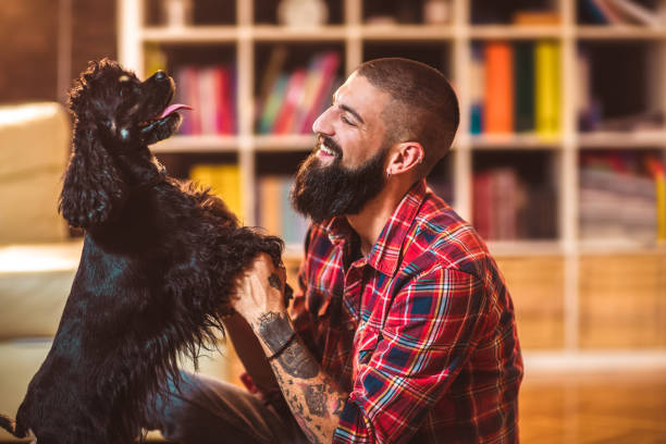 istock Handsome man with cute dog at home 1049204404