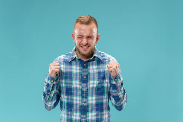 istock Beautiful man looking suprised and bewildered isolated on blue 1049205096