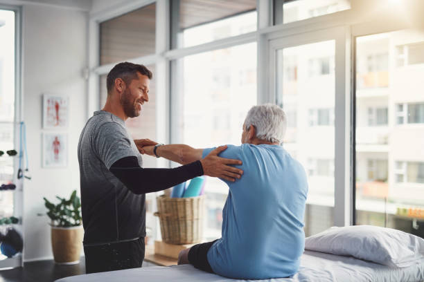 Your body seems to be recovering well Shot of a young male physiotherapist assisting a senior patient in recovery physical therapy stretching stock pictures, royalty-free photos & images