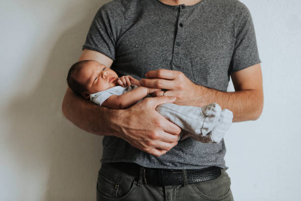 istock Young father holding his baby 1049210928
