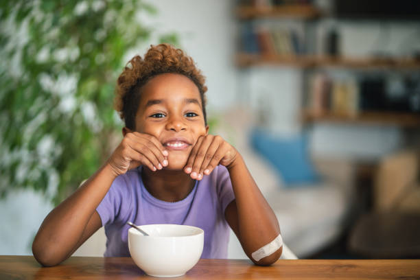 istock Playful girl making face at breakfast 1049210964