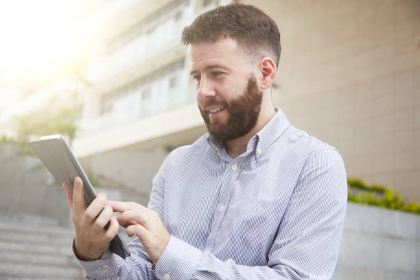 istock Smiling man reading news online 1049211364