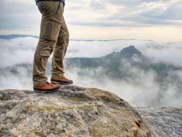 Person stand on the peak. Silhouette of man body. stock photo