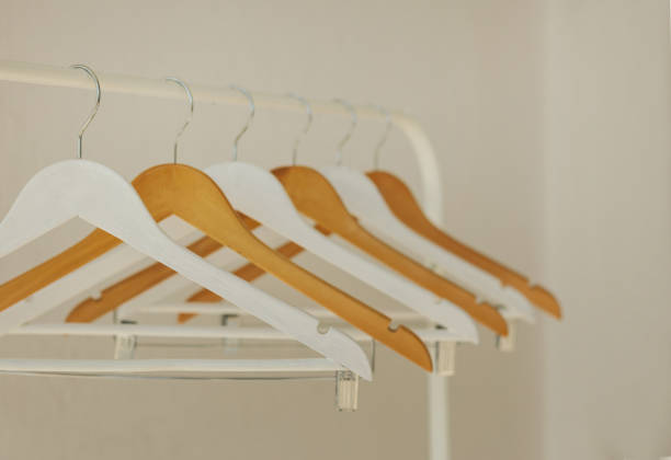 istock White row of hangers on the rack. 1049214424