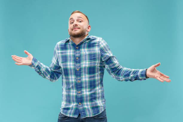 istock Beautiful man looking suprised and bewildered isolated on blue 1049217028