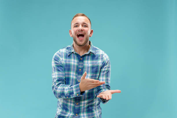istock Beautiful male half-length portrait isolated on blue studio backgroud. 1049217088