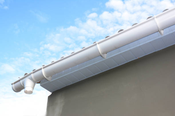 istock Roof gutter repair. Rain gutter installation with holders, drain downspout pipe. Unfinished house Guttering. 1049223172