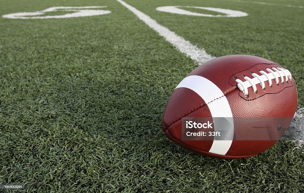 American Football with the Fifty Beyond American Football with the Fifty Yard Line Beyond American Football - Ball Stock Photo