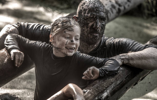 istock Father and daughter mud run 1049230114