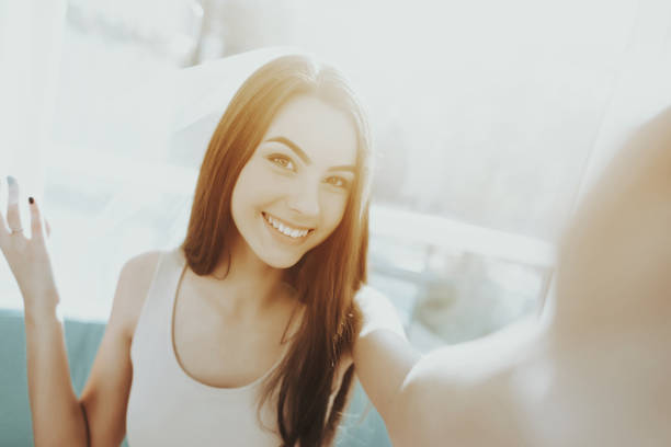 Smiling Girl Is Doing A Selfie Before Hen-party. Pre-wedding Care Concept. Beautiful Shiny Smile. Camera Staring. Sunny Day. Good Mood. Young And Attractive. Happy Holiday. Long Hair.