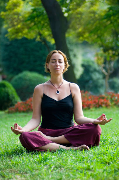 istock woman meditating in nature 1049238294