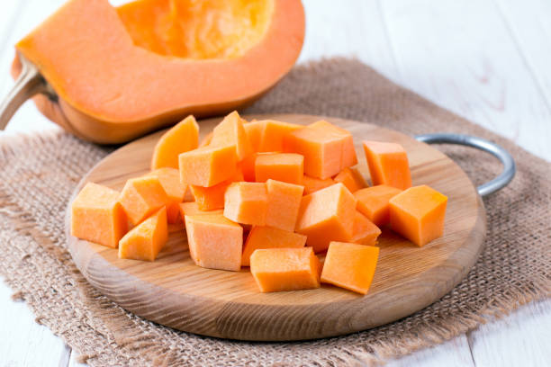 istock Cubes of pumpkin on cutting board 1049240686