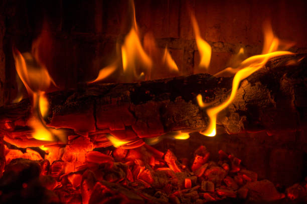 istock Burning log coal in the fireplace background 1049241388