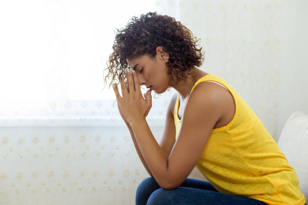 istock Woman Praying at home 1049241980