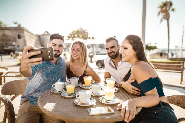 istock friends at the cafe take a selfie 1049244534