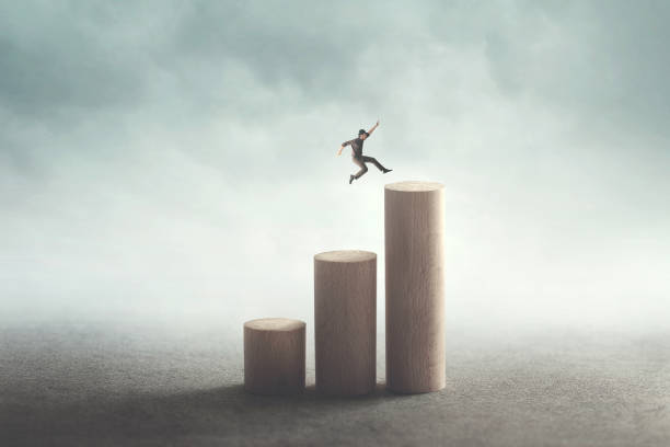 success and ambition concept man big jump to reach the top figurine photos stock pictures, royalty-free photos & images