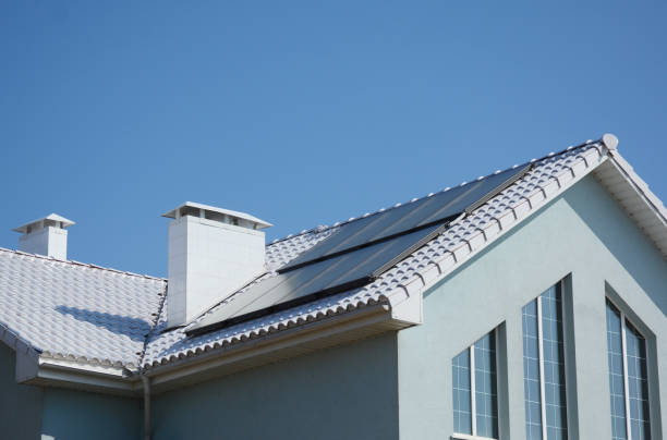 istock Modern passive house with solar panels and white roof for energy efficiency. 1049248654