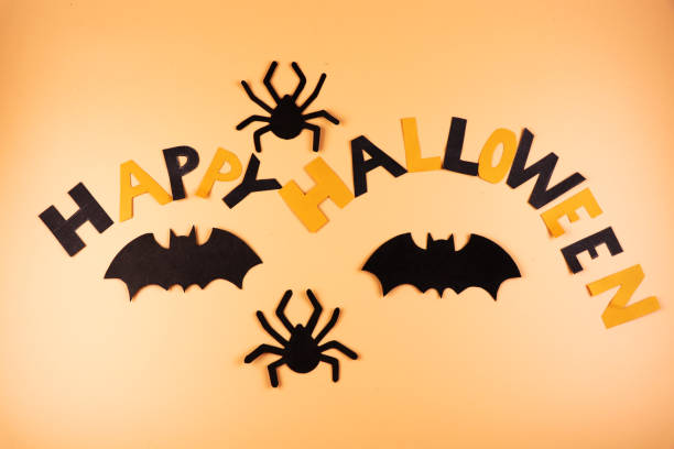 istock A Happy Halloween sign created from colour paper and as decoration using two spiders and two black bats 1049249208