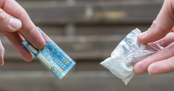 Traficante de drogas vende drogas por dinero en efectivo photo