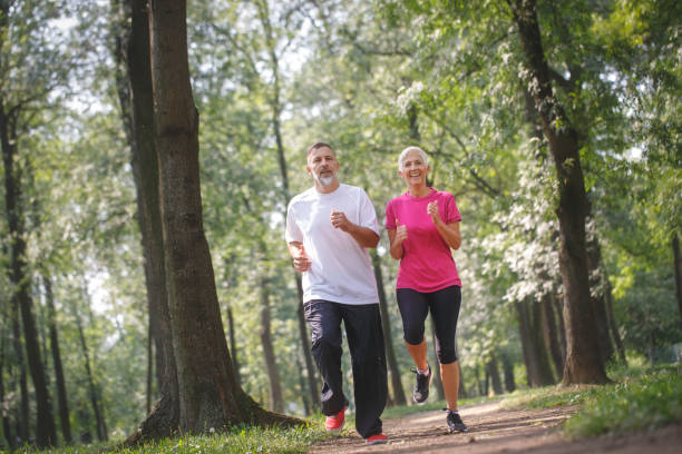 istock Senior couple jogging outdoors 1049251378