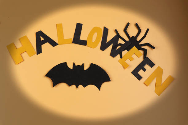 istock Black spider, black bat and happy halloween sign. Scare? 1049251422