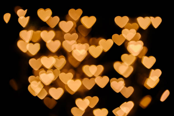 istock golden hearts bokeh lights on black backdrop 1049255286