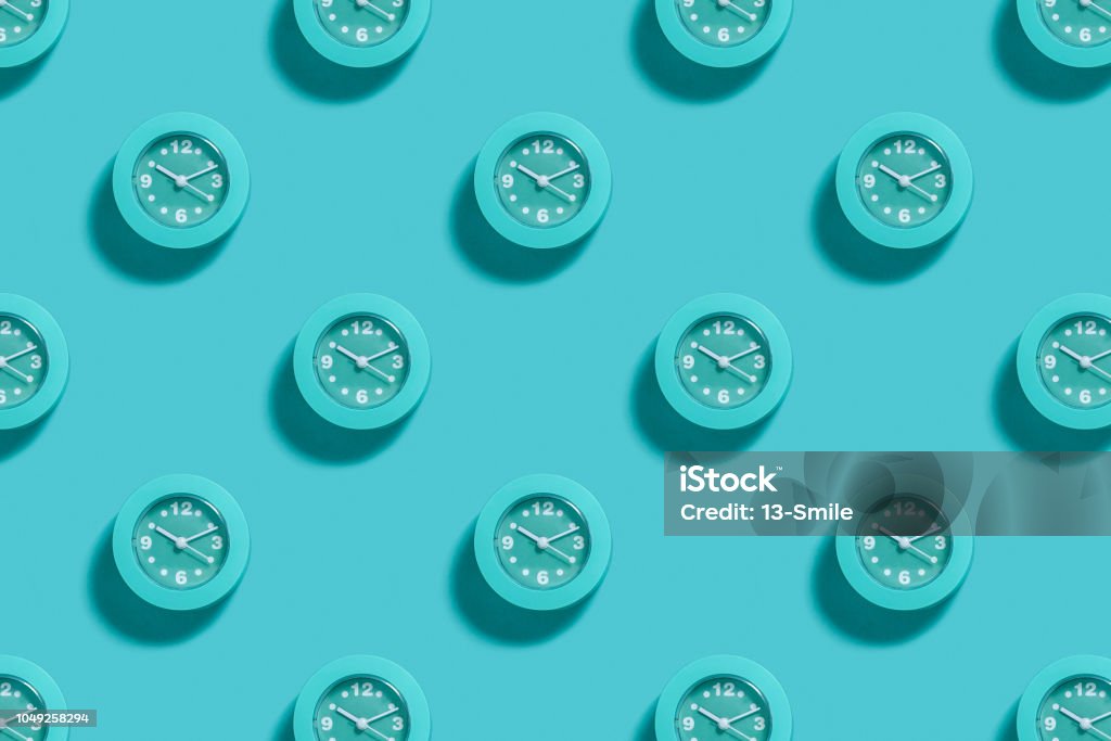 Pattern of blue alarms on light blue background Pattern of blue alarms on pastel blue background. Minimal monochrome concept Clock Stock Photo