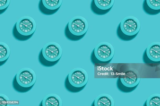 Pattern Of Blue Alarms On Light Blue Background Stock Photo - Download Image Now - Clock, Time, Backgrounds