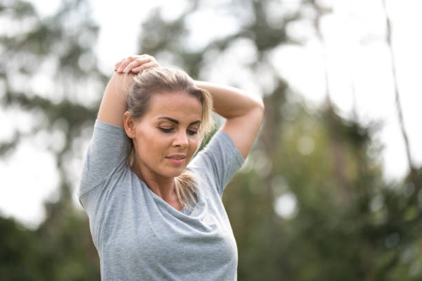 istock Young female athlete stretching outdoors in nature 1049259126