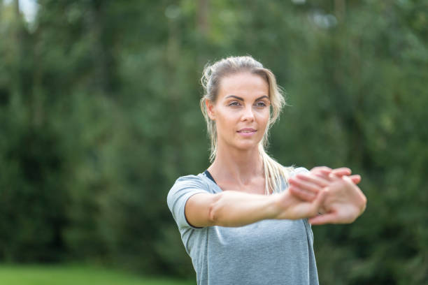 istock Young female athlete stretching outdoors in nature 1049259136