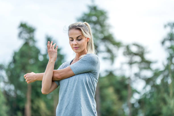 istock Young female athlete stretching outdoors in nature 1049259152