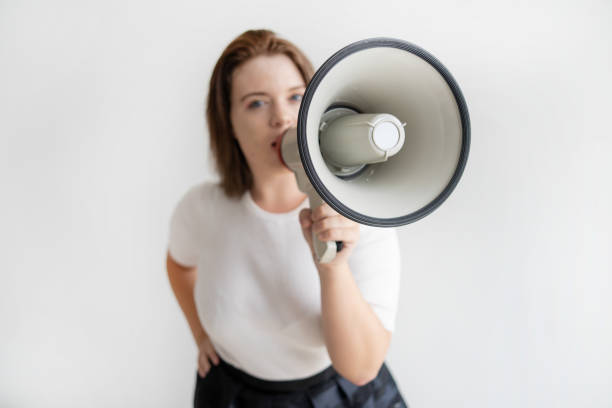 istock Young female activist talking about her ideas in megaphone 1049262048