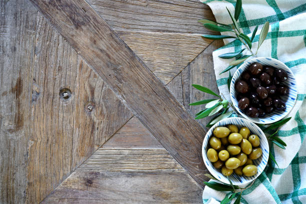 istock Wooden table with checkered tablecloth and olives 1049264244