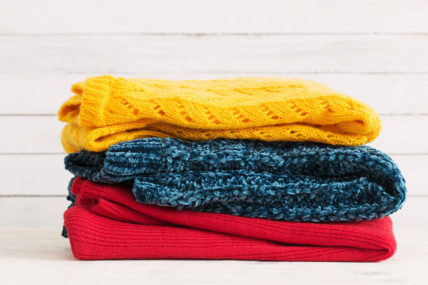 istock knitted sweaters on  wooden background 1049265768