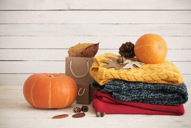istock knitted sweaters on  wooden background 1049265786