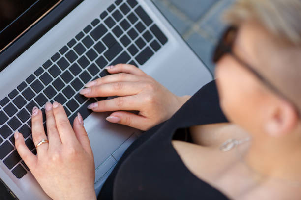 istock Woman with laptop typing keyboard 1049266526
