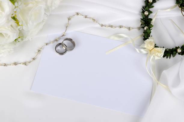 istock wedding invitation - blank wedding invitation with wedding rings and  white roses 1049266608