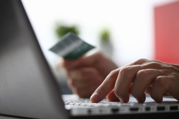 istock Male arms hold credit card press buttons making 1049266710
