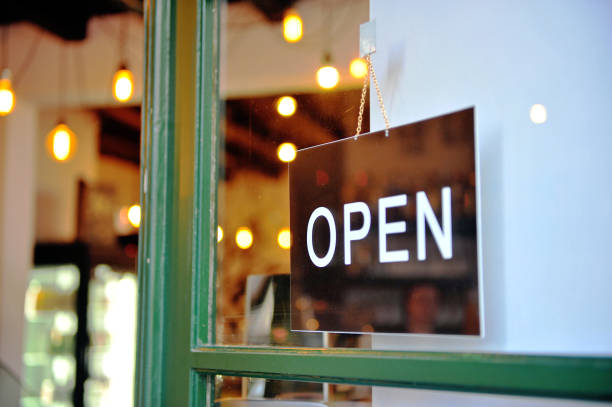 Black hanging open sign in the green wooden door of retail store, business background Black hanging open sign in the green wooden door of retail store, business background franchising photos stock pictures, royalty-free photos & images