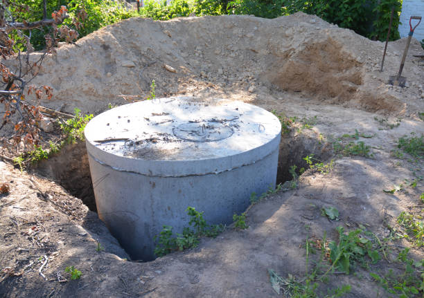 istock Installing sewer water tank with manhole cover outdoors 1049268206
