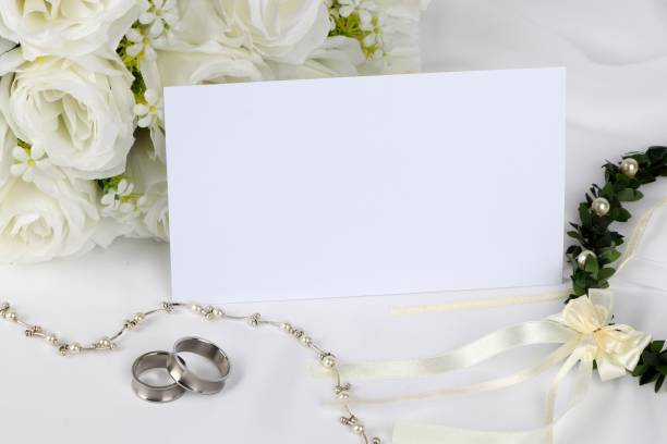 istock wedding invitation - blank wedding invitation with wedding rings and  white roses 1049269984