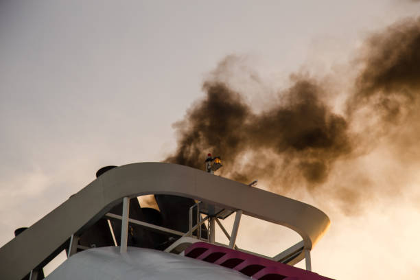 istock Black smoke from a starting ship in the harbor 1049276770