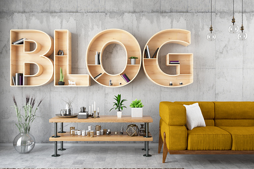 Blog bulb sign on black brick wall with armchair