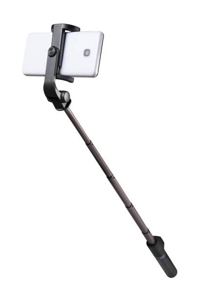 selfie stick einbeinstativ und handy isoliert auf weiss mit beschneidungspfad - einbeinstativ stock-fotos und bilder